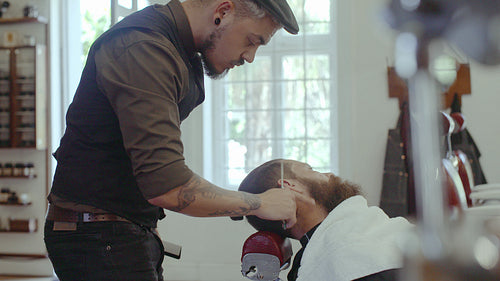 Barber grooming beard at barbershop