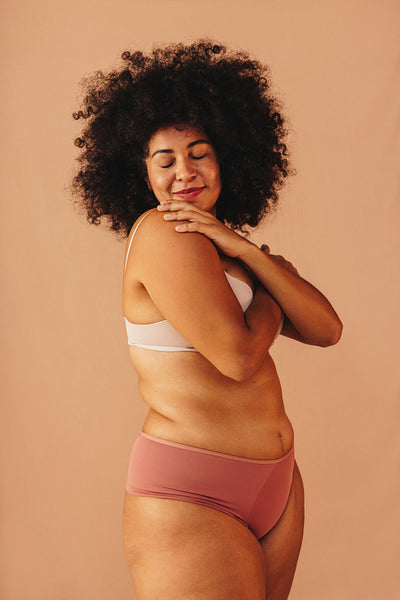 Beautiful woman embracing her natural body in a studio