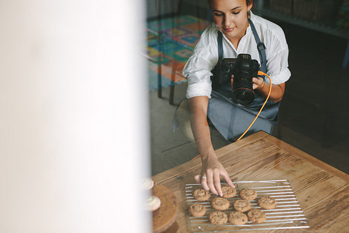 Woman chef photographing pastries