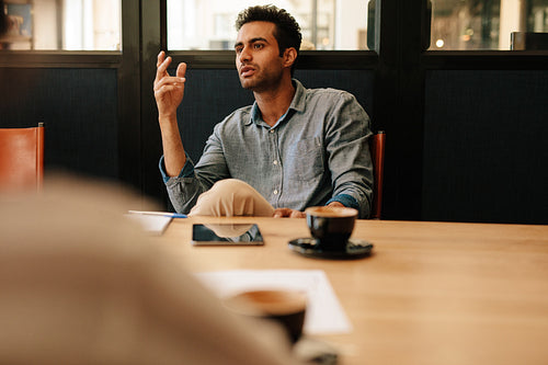 Businessman talking with coworkers in office