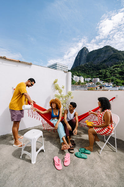 Group of friends relaxing outdoors in Rio de Janeiro with mountains nearby