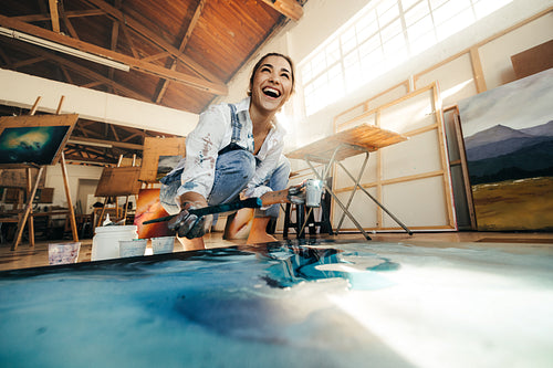 Painter laughing cheerfully in her atelier