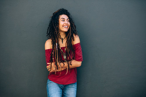 Portrait of a woman standing against a wall