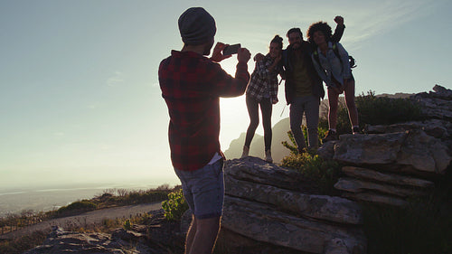Man taking picture of his friends during hike