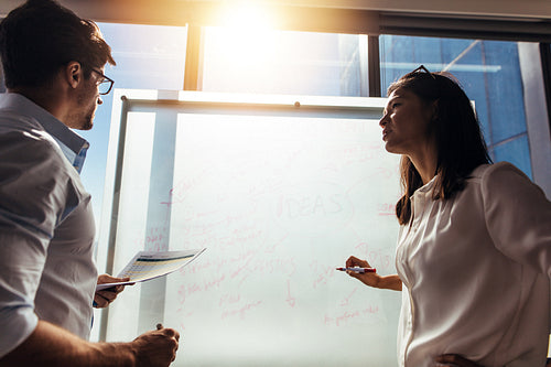 Business investors discussing business ideas in conference room. 