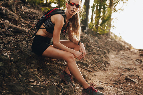 Female runner taking break on trail run