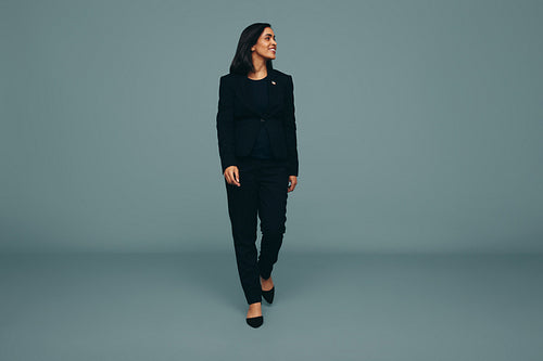 Young American politician walking towards the camera in a studio