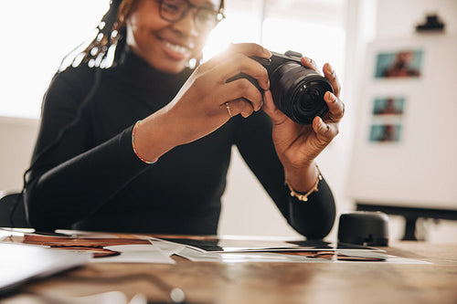 Photographer holding a dslr camera in her camera
