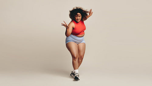 Confident body moves: Plus size woman having fun with her body in a dance workout