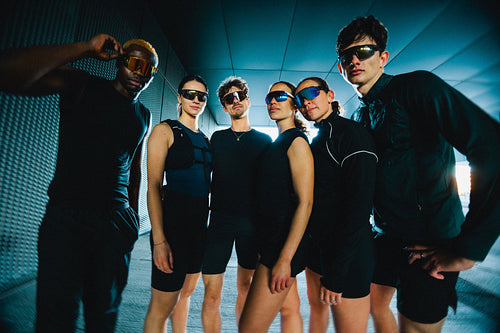 Run club friends group portrait in sporty sunglasses posing together with confident fitness style