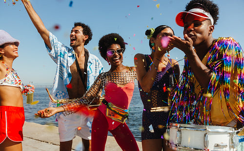 Friends celebrate at brazilian carnaval on beach