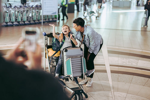 Family at airport taking photos and having fun