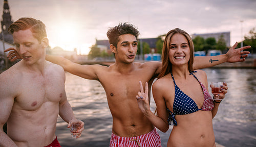 Young people together by the lake having fun