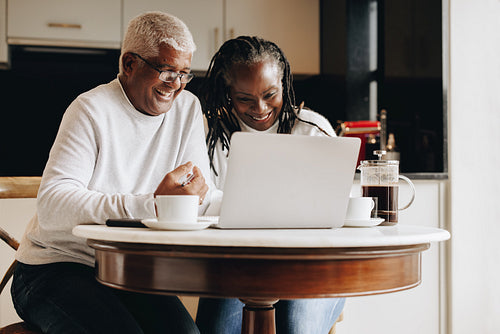 Cheerful senior couple having a video call on a laptop