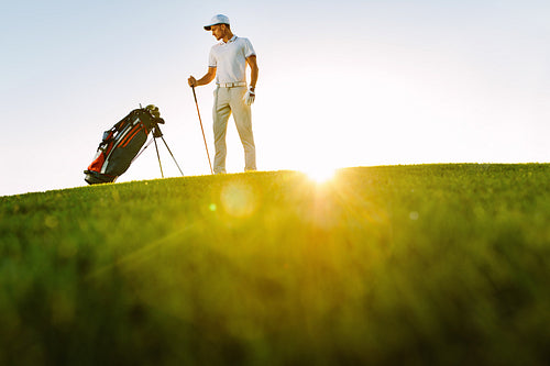 Male golfer standing on golf course