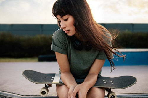 Female skateboarded relaxing at skate park