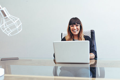 Smiling businesswoman sitting in office