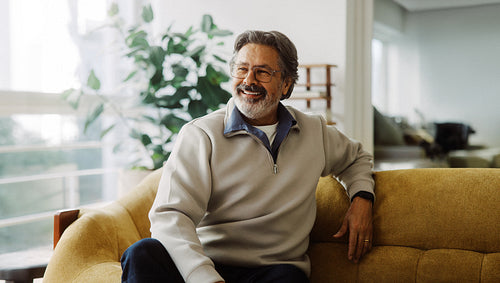 Senior man relaxing on a sofa at home