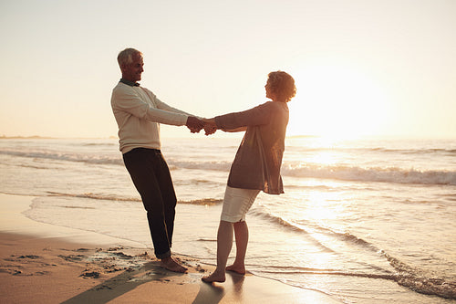 Mature couple enjoying themselves on the beach