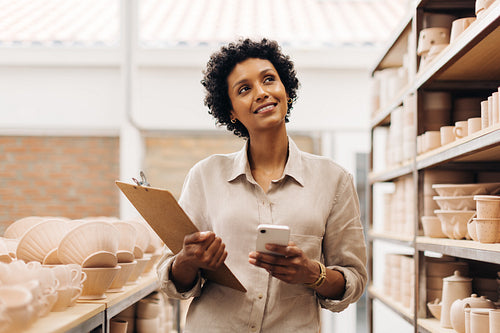 Ceramic shop owner contemplating new ideas for her store
