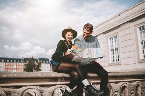 Young couple looking at a city map.
