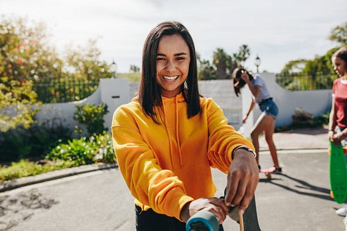 Girls skating in the street on a sunny day