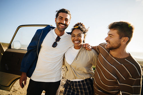 Roadside joy: Friends enjoying a breezy moment by the camper van