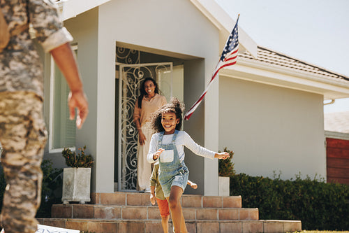 Happy young kids welcoming their father from the army