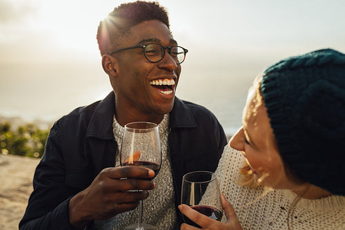 Happy couple with wine enjoying at picnic