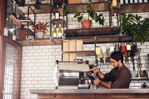 Male barista making a cup of coffee