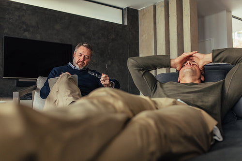 Depressed man visiting psychologist
