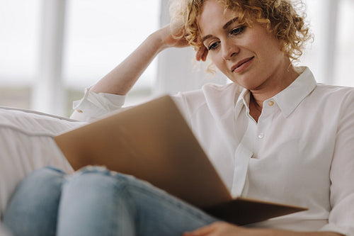 Close up of a woman working on laptop at home