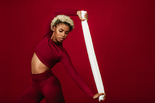 Fitness woman doing workout using a towel