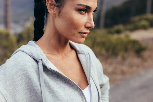 Female runner standing outdoors in morning