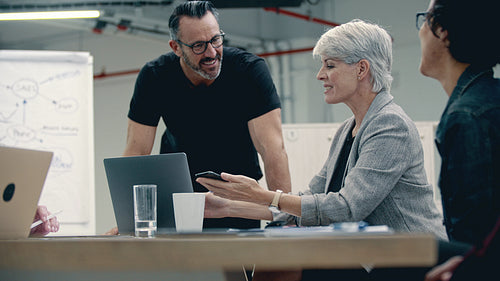 Business people applauding for a colleague in meeting