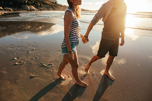 Loving couple walking on sea shore