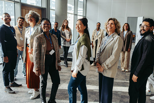Audience at a business seminar in the workplace looking happy and engaged