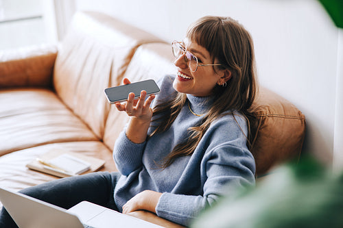 Smiling businesswoman having a phone call in a modern office