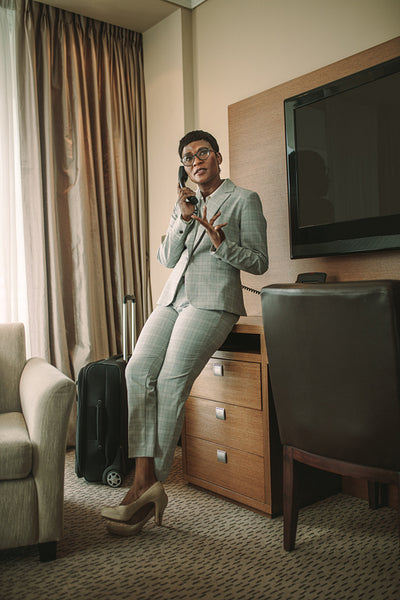 African woman on business tour making phone call from hotel room