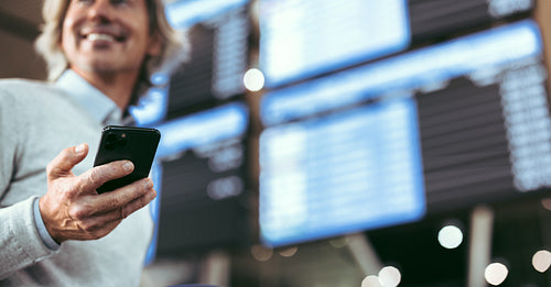 Man at airport with mobile phone