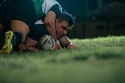 Rugby player pins down opponent