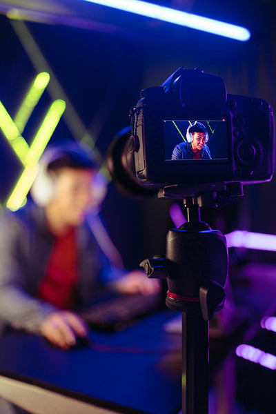 Gamer live streaming his gameplay to his online subscribers on a streaming service