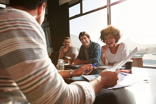 Mixed race young people discussing new and creative business ideas