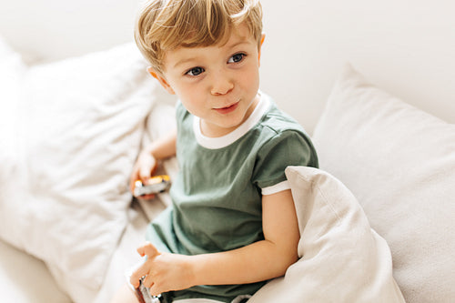Cute boy sitting on sofa