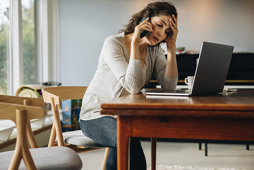Stressed out woman talking on phone
