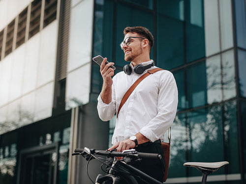 Businessman talking on cell phone standing on street