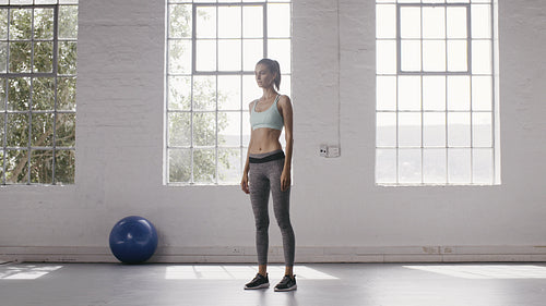 Woman exercising perfect squats in fitness studio