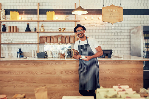 Happy young coffee shop owner