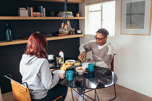 Couple having breakfast together at home