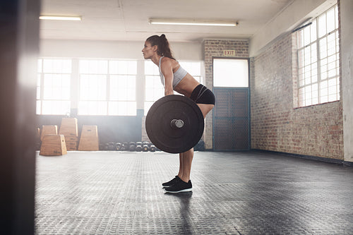 Fitness woman doing weight lifting at health club.
